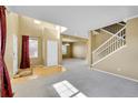Spacious room with hardwood floors, carpet, a staircase, and large windows providing ample natural light at 3790 Aspen Hollow Ct, Castle Rock, CO 80104