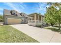 Charming home with a two-car garage and inviting front porch, enhanced by a well-manicured lawn and clear blue skies at 3342 Springmeadow Cir, Castle Rock, CO 80109