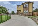 Modern home exterior with stone accents and a concrete driveway at 4190 W Alameda Ave, Denver, CO 80219