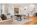 Inviting living area features modern decor and hardwood floors leading to the staircase at 4190 W Alameda Ave, Denver, CO 80219