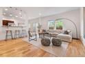 Open living room with modern furniture, a large window, and hardwood floors throughout at 4190 W Alameda Ave, Denver, CO 80219