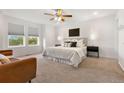 Serene primary bedroom featuring natural light from the large windows at 4190 W Alameda Ave, Denver, CO 80219