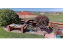 Relaxing backyard setting with comfortable seating and a picturesque view of open fields at 10057 Cedaridge Way, Highlands Ranch, CO 80129