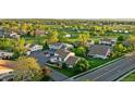 Expansive aerial view showcasing the neighborhood, with lush greenery, ponds, and well-spaced homes at 8767 Chase Dr # 195, Arvada, CO 80003