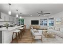 Open-concept living space featuring a kitchen island with bar seating, a comfortable sofa, and ample natural light at 8767 Chase Dr # 195, Arvada, CO 80003