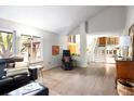 Spacious living room featuring natural light, hardwood floors, and easy access to the staircase at 10572 E Orchard Pl, Englewood, CO 80111