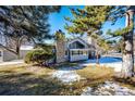 Rear view of house showing stone chimney and landscaping at 14393 E Marina Dr, Aurora, CO 80014
