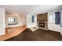 Living room with a stone fireplace and hardwood floors at 14393 E Marina Dr, Aurora, CO 80014