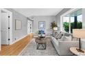 Bright living room with hardwood floors, neutral paint, and large windows, offering a cozy ambiance at 2735 S Dahlia St, Denver, CO 80222