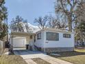 A quaint home with a carport and stone accents on the base, showcasing curb appeal at 2650 W Mississippi Ave, Denver, CO 80219