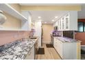 Bright kitchen boasting granite counters, stainless appliances and updated cabinets at 3482 S Eagle St # 102, Aurora, CO 80014