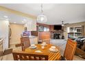 Cozy living room featuring a fireplace, dining area, and access to the outdoors at 3482 S Eagle St # 102, Aurora, CO 80014