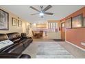Open living room featuring a view into the kitchen with adjacent front door access at 3482 S Eagle St # 102, Aurora, CO 80014