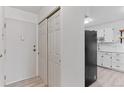 Bright entryway leading to a modern kitchen with stainless steel appliances and white cabinetry at 595 S Alton Way # 1C, Denver, CO 80247