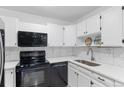 Well-lit kitchen featuring a stainless steel sink, modern appliances, and ample counter space at 595 S Alton Way # 1C, Denver, CO 80247
