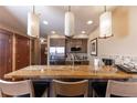 Modern kitchen featuring granite countertops, stainless steel appliances, and pendant lighting at 1521 Ski Hill Rd # 8318, Breckenridge, CO 80424