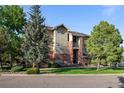 Beautiful exterior of a multi-story home with lush landscaping and mature trees at 8422 S Upham Way # G60, Littleton, CO 80128