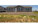Charming single-story home with gray siding, white trim, and a well-kept yard at 11809 Pass Me By Rd, Strasburg, CO 80136