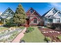 Inviting front yard with walkway leading to this red and grey home, nestled between colorful houses at 233 W 3Rd Ave, Denver, CO 80223