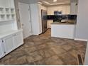 Modern kitchen featuring stainless steel appliances, granite countertops, and ample cabinet space at 2238 S Nile Ct, Aurora, CO 80014