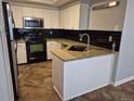 Modern kitchen featuring stainless steel appliances, granite countertops, and ample cabinet space at 2238 S Nile Ct, Aurora, CO 80014