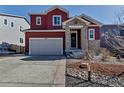 Inviting two-story home featuring a two-car garage and stone-clad entryway at 4840 Point Mesa St, Castle Rock, CO 80108