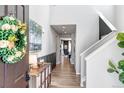 Welcoming foyer with neutral walls, wood floors, and a view into the dining area at 4840 Point Mesa St, Castle Rock, CO 80108
