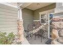 Cozy covered front porch with stone pillars, seating, and a welcoming atmosphere at 6187 Wescroft Ave, Castle Rock, CO 80104