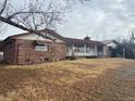 Single story home with stone exterior and large yard at 6397 Ute Hwy, Longmont, CO 80503