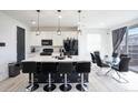 Open kitchen boasts a spacious island with seating and is adjacent to the dining area at 26985 E Bayaud Ave, Aurora, CO 80018