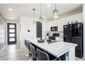 Bright kitchen features a center island with barstool seating and sleek, modern appliances at 26985 E Bayaud Ave, Aurora, CO 80018