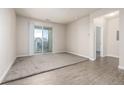 Bright living room with sliding glass doors to a balcony and views of the neighborhood at 4100 Albion St # 523, Denver, CO 80216