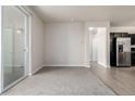 Open floor plan features living room with balcony and kitchen with stainless steel appliances at 4100 Albion St # 523, Denver, CO 80216