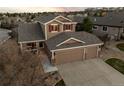 An overhead shot showcasing the home's roof, three-car garage, and neighborhood at 1271 Berganot Trl, Castle Pines, CO 80108