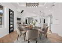 Open concept dining room with hardwood floors and modern lighting at 30410 E 161St Ave, Brighton, CO 80603