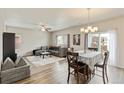 Open-concept living and dining area with modern furnishings and hardwood flooring at 7232 Shavano Ave, Frederick, CO 80504