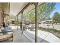 Relaxing covered porch offers an outdoor living space with neighborhood views and comfortable seating at 10457 Owens Cir, Broomfield, CO 80021