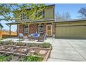 Inviting front patio area with comfortable seating, a well-manicured garden, and a cozy atmosphere at 10457 Owens Cir, Broomfield, CO 80021