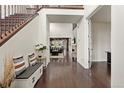Grand entryway featuring dark wood floors, a staircase, and an open view into the living room at 8464 E 55Th Pl, Denver, CO 80238