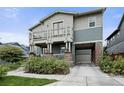Charming two-story home with a balcony, porch, a covered parking area and well-maintained landscaping at 8464 E 55Th Pl, Denver, CO 80238