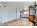 Spacious living room with hardwood floors, ample natural light, and unique wood shelving at 925 Quitman St, Denver, CO 80204