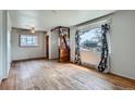 Bright living room with hardwood floors, two windows, and a ceiling fan at 925 Quitman St, Denver, CO 80204