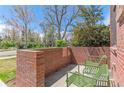 Relaxing patio with two chairs surrounded by a low brick wall at 1833 E Jewell Ave, Denver, CO 80210