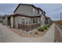 Attractive townhome exterior featuring private outdoor space with a porch and decorative landscaping at 11568 Dewey St, Parker, CO 80138
