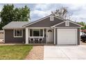 Charming single-story home featuring a well-manicured lawn, attached garage, and inviting front entrance at 8240 Grandview Ave, Arvada, CO 80002