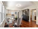 The dining area features hardwood floors, great light, and provides access to the adjacent rooms at 3336 W 35Th Ave, Denver, CO 80211