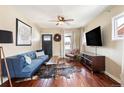Cozy living room with hardwood floors, a blue sofa, and lots of natural light from windows at 3336 W 35Th Ave, Denver, CO 80211