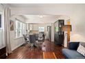 Inviting living room seamlessly connects to a modern kitchen and dining area with beautiful hardwood floors at 3336 W 35Th Ave, Denver, CO 80211