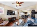 Open-concept living room with wood floors flowing into an eat-in kitchen, perfect for entertaining at 3336 W 35Th Ave, Denver, CO 80211
