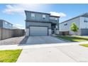 Charming two-story home boasts a well-manicured lawn and modern architectural details at 13427 Broad Wing Dr, Parker, CO 80134